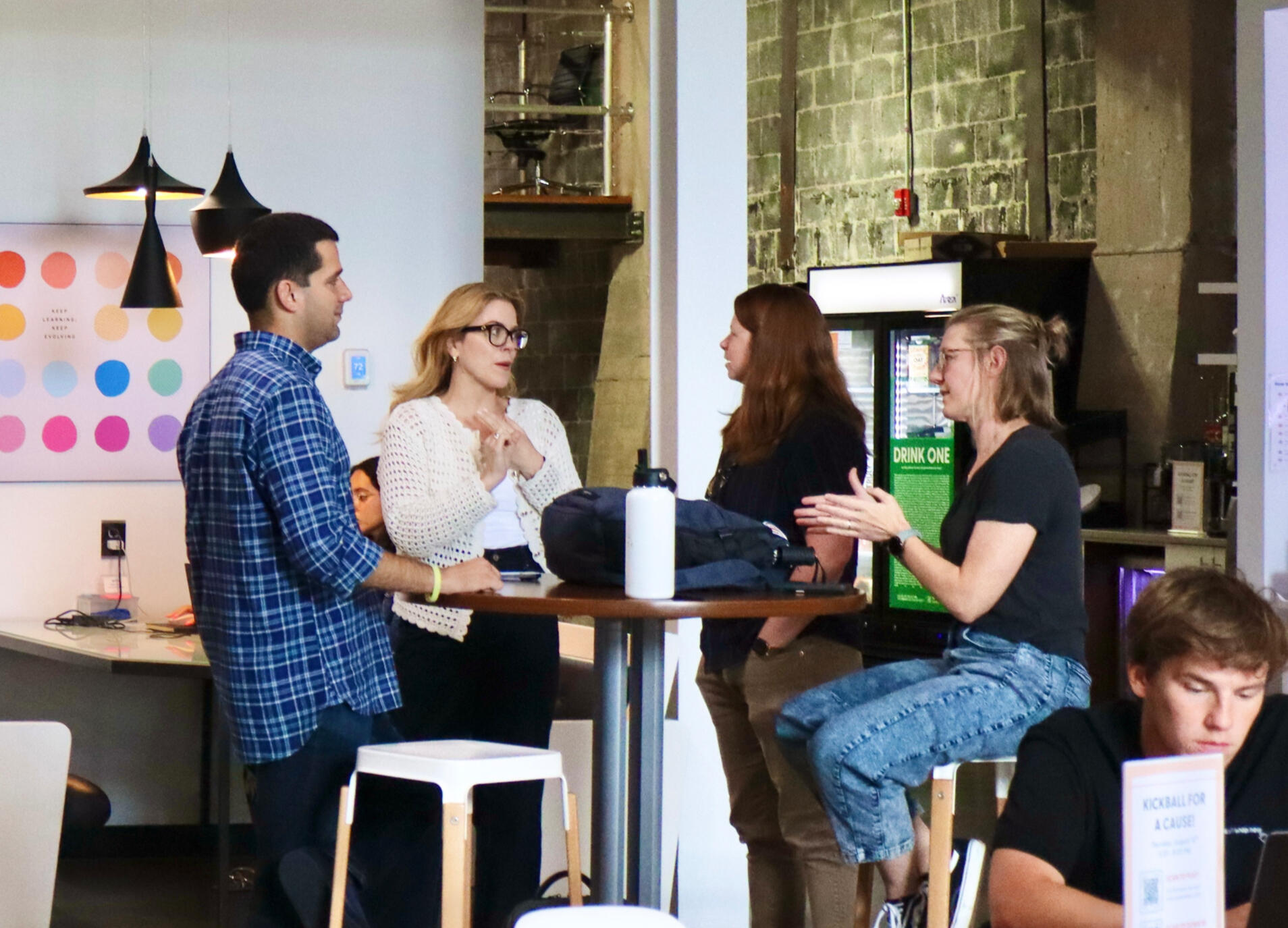 Chat four people gathered around a table talking